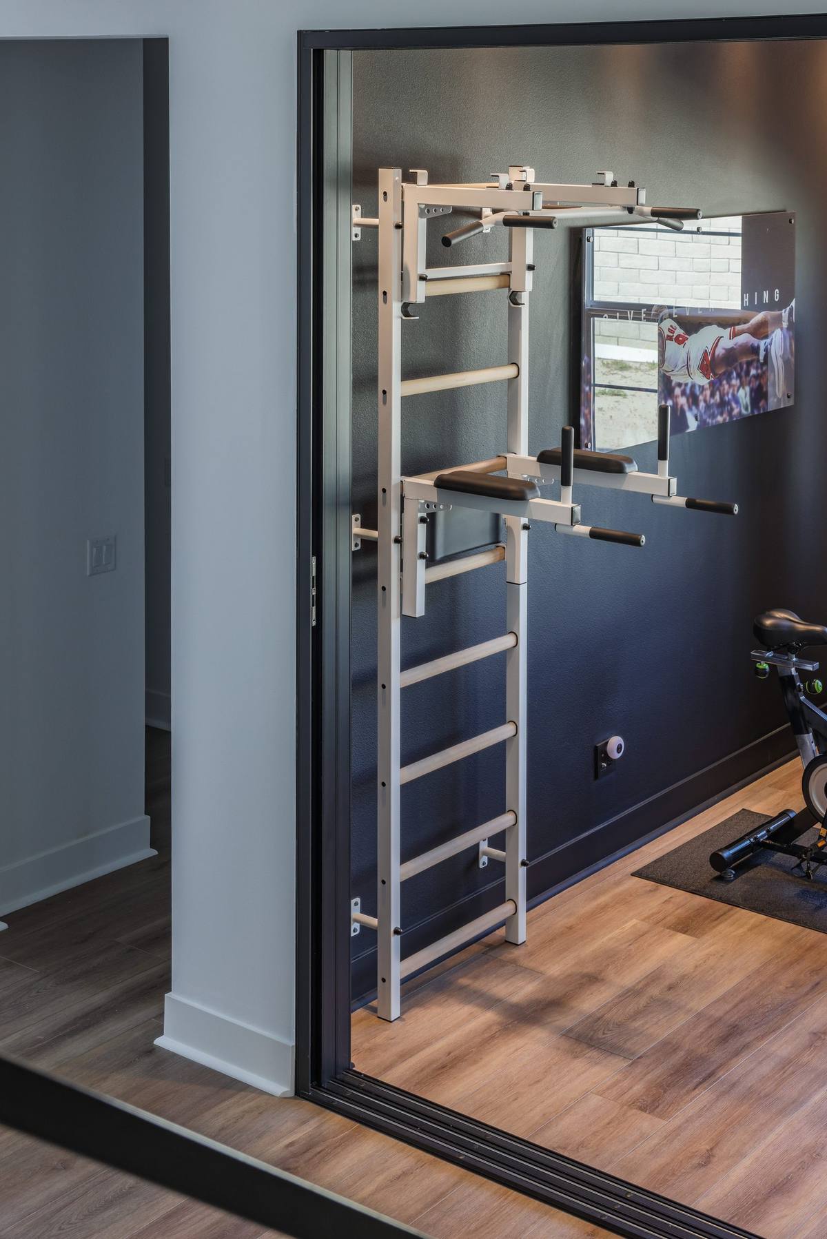 BenchK wall bar system installed in a modern home gym